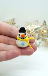 Miniature needle felted snowman in a hat