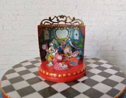 miniature puppet theater in the style of alice.dollhouse miniature.