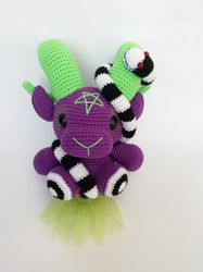 Purple baphomet with neon green curled horns and earthworm - horror movie characters