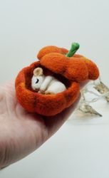 Miniature needle felted mouse sleeping in a pumpkin