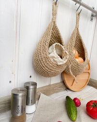 Suspended storage of vegetables and fruits. Jute baskets. Kitchen storage. Onion garlic basket. Wall jute potato basket