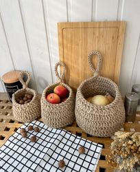 Set of hanging wall baskets for vegetables, fruits. Crochet jute basket, potato onion and garlic storage.