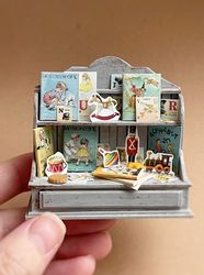 Miniature set with children's books and toys on the shelf for playing with dolls, dollhouse, scale 1:12, miniature pastr
