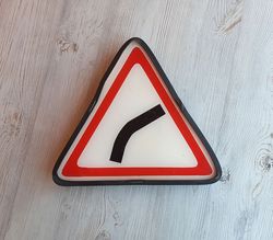 Gentle curve ahead Russian traffic road sign vintage - triangle Soviet traffic sign outdoor
