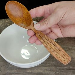 Handmade wooden spoon from natural buckthorn wood with decorated handle for eating