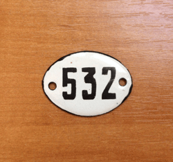 White black oval number sign 532 apartment address plate vintage