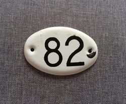 Apt room door number plate 82 - white black enamel metal address sign vintage