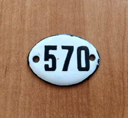 White black oval address number sign 570 apartment plaque vintage