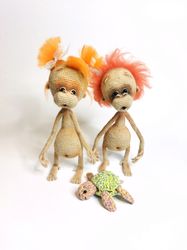 Two stuffed toys orangutans. Amigurumi monkeys, crocheted. Cute baby stuffed monkeys orangutans toys. Gift lovers monkey