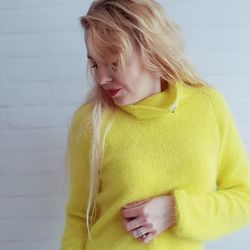 Delicate and fluffy knitted angora sweater in bright yellow.
