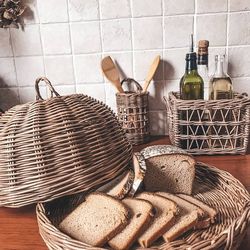 Wicker kitchen storage set. Brown woven bread basket. Round breadbox. Rectangular kitchen storage basket. Utensil holder