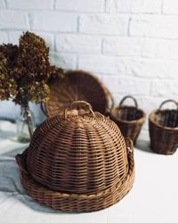 Wicker kitchen storage set. Brown woven bread basket. Round bread tray with handle. Utensil holder. Kitchen set of 4