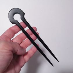 Black wooden hairpin with two teeth.