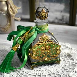 glass bottle green for storing perfumes and aroma oils with a voluminous decor