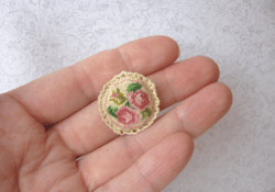 Embroidery kit for a miniature sofa cushion for a dollhouse in 1/12 scale. Small roses on beige.