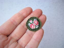 Embroidery kit for a miniature sofa cushion for a dollhouse in 1/12 scale. Small roses on dark green.