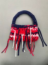 Crocheted baguette bag with metal button clasp