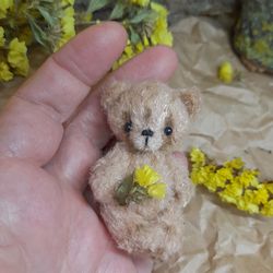 Crochet handmade miniature soft toy teddy bear.