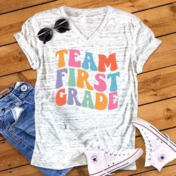 Team First Grade, Retro Back To School First Grade Teacher Novelty Graphic Unisex V Neck Graphic Tee T-Shirt
