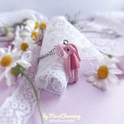 Cute pink bunny necklace in the style of a textile rabbit doll made of polymer clay
