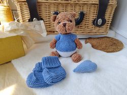 Teddy bear and booties baby gift for mom.Teddy bear, blue baby shoes, mini heart. Nice gift for the birth of a baby