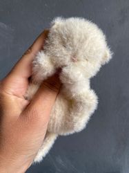 Knitted toy realistic sleeping kitten available. White cute kitten toy