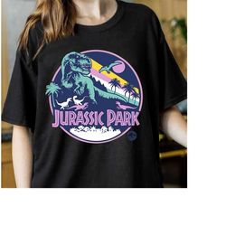 Jurassic Park Purple Retro Dinosaur Scene Graphic shirt, Jurassic World Outfits, Jurassic Park 2023, Holidays 2023 Match