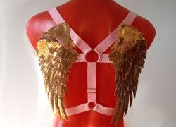 Angel wings harness gold on black elastic.