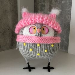 Grey owl.Pink hat and scarf.Rainbow eyes.