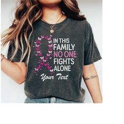 Custom In This Family No One Fights Alone Breast Cancer Comfort Colors Shirt, Cancer Awareness, In October We Wear Pink