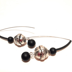 Modern long earrings made of steel, acrylic and glass beads