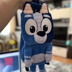 Handmade crochet backpack socks in the shape of dog bluey, perfect for adults and kids. A unique and adorable gift.