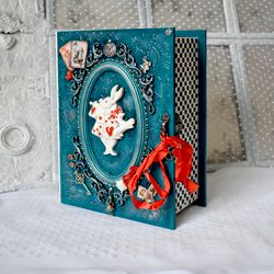 A turquoise box with rabbit-herald Alice in Wonderland