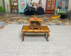 Lion in a cage. Dollhouse miniature. 1:12.
