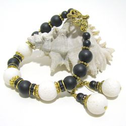 Handmade monochrome jewelry set of bracelet and earrings made of white coral and black glass beads