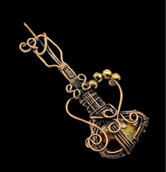 melodic majesty: dragon bloodstone wire wrapped guitar pendant