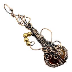 Earthen Rhapsody: Red River Jasper Copper Wire Wrapped Guitar Pendant for Musical Elegance and Natural Harmony
