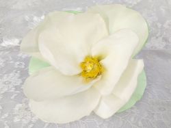 Artificial cloth champagne magnolia flower. Satin ribbon fabric flower for clothing. Sewing embellishment for dress