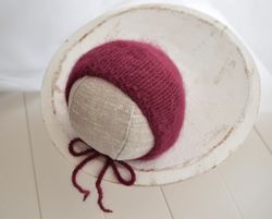 Newborn knitted burgundy bonnet photo props . Vine colour angora hat for new baby girl first photo shoot. New baby girl