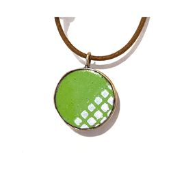 Enamel pendant green and white with cord.