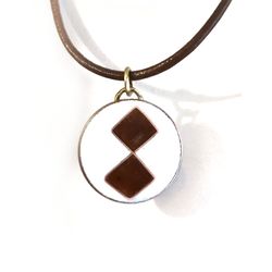 Geometric cloisonne fired enamel pendant with brown leather
