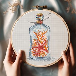 glass bottle with red starfish and orange corals cross-stitch pattern ocean treasure in bottle embroidery sea travel