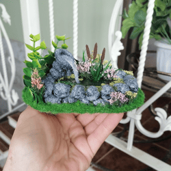 Miniature pond for a doll garden.