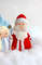 Felt grandfather Frost and Snow maiden toys against the background of snow and snowflakes