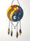 Stained glass Yin Yang suncatcher in art deco style in blue and yellow with sun and moon symbols on a white background.jpg