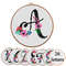 Cross stitch alphabet, letter a with flowers, canvas aida fabrick and round hoop.jpg