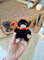 stuffed black niffler toy in hufflepuff scarf.jpg