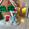 bear next to the gingerbread house