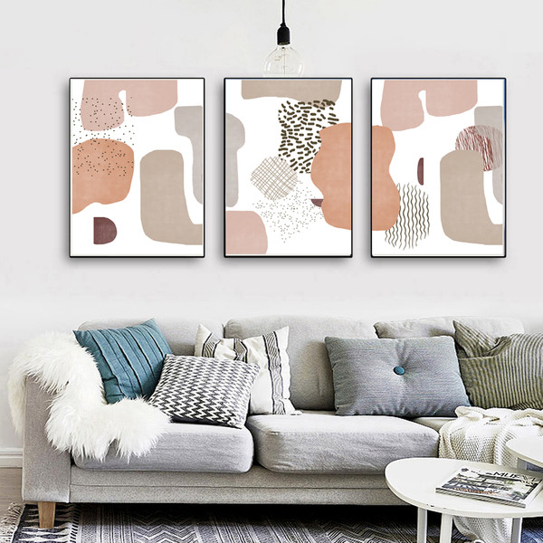 three posters on the wall in pastel colors