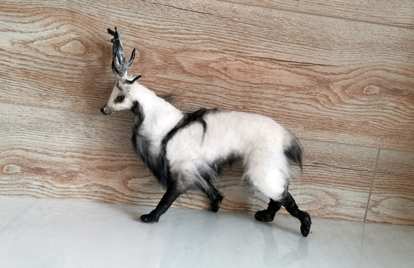 a soft toy in a mixed technique deer